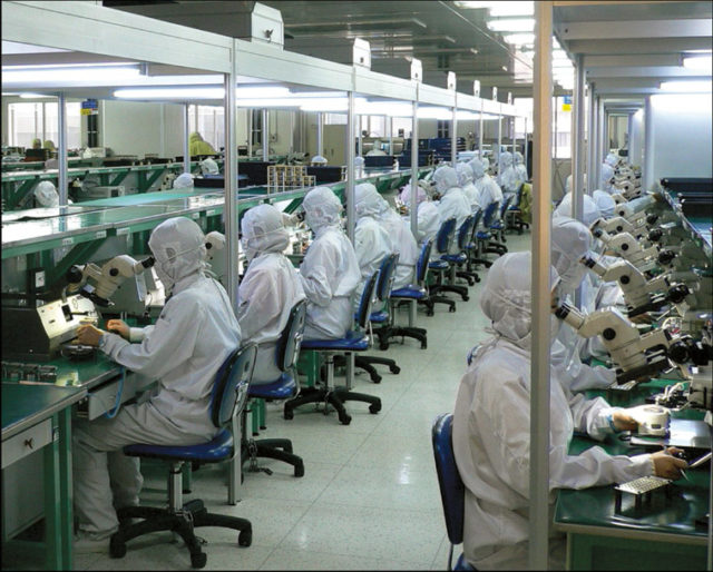 Workers assembling and testing fiber optic systems. Photo: Steve Jurvetson