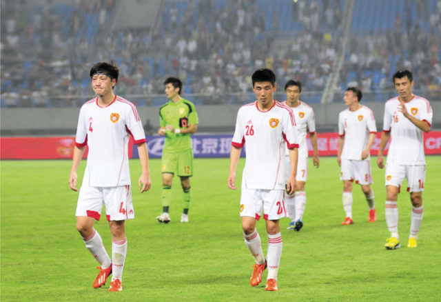 Members of the Chinese national football team walk dejectedly off the field after their 1-5 drubbing by a young Thai team in Hefei, Anhui province, 15 June 2013. Source: ImagineChina