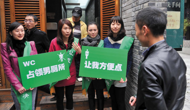 Women protesters outside a men’s restroom. Source: Mop.com