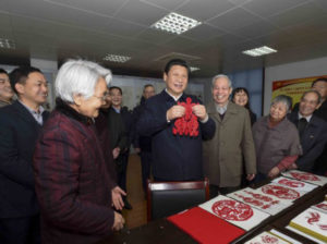A beaming Xi Jinping with his papercut goats Source: politics.people.com.cn